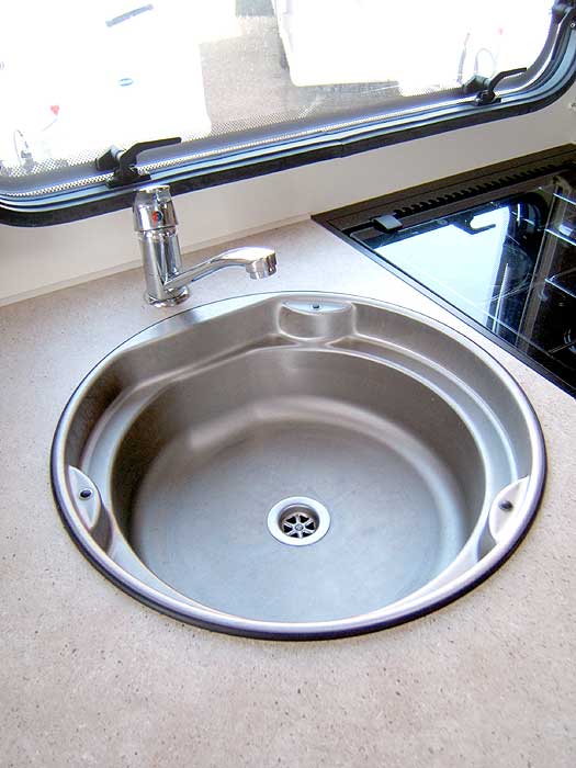 The recessed stainless steel sink with single mixer tap.